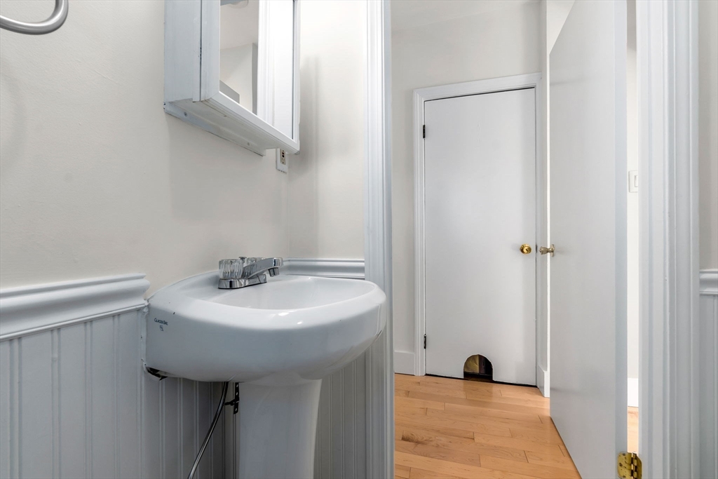 14 1/2 Hampshire Street Danvers, MA 01923 - Photo 17 of 37 a bathroom with a sink a toilet and a mirror