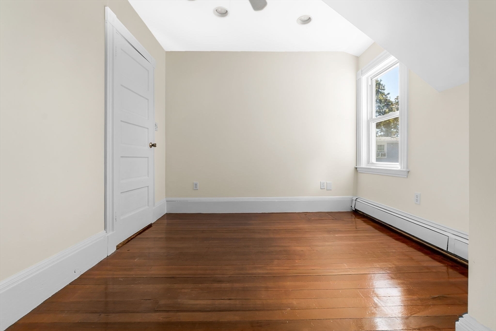 14 1/2 Hampshire Street Danvers, MA 01923 - Photo 24 of 37 a view of an empty room with wooden floor and a window