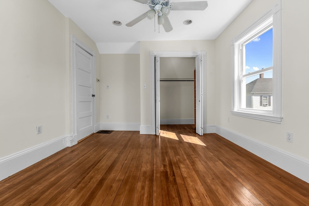 14 1/2 Hampshire Street Danvers, MA 01923 - Photo 27 of 37 a view of an empty room with a window and wooden floor