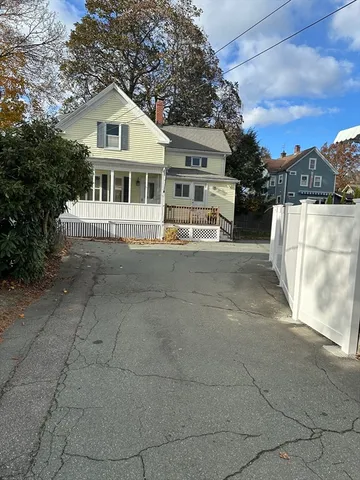 a view of a house with a yard and sitting area