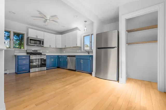 a kitchen with kitchen island a cabinets and refrigerator