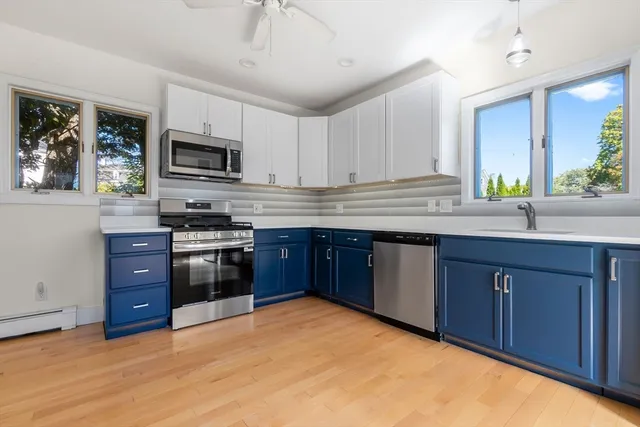 a kitchen with stainless steel appliances granite countertop a stove a sink dishwasher a refrigerator and a microwave oven