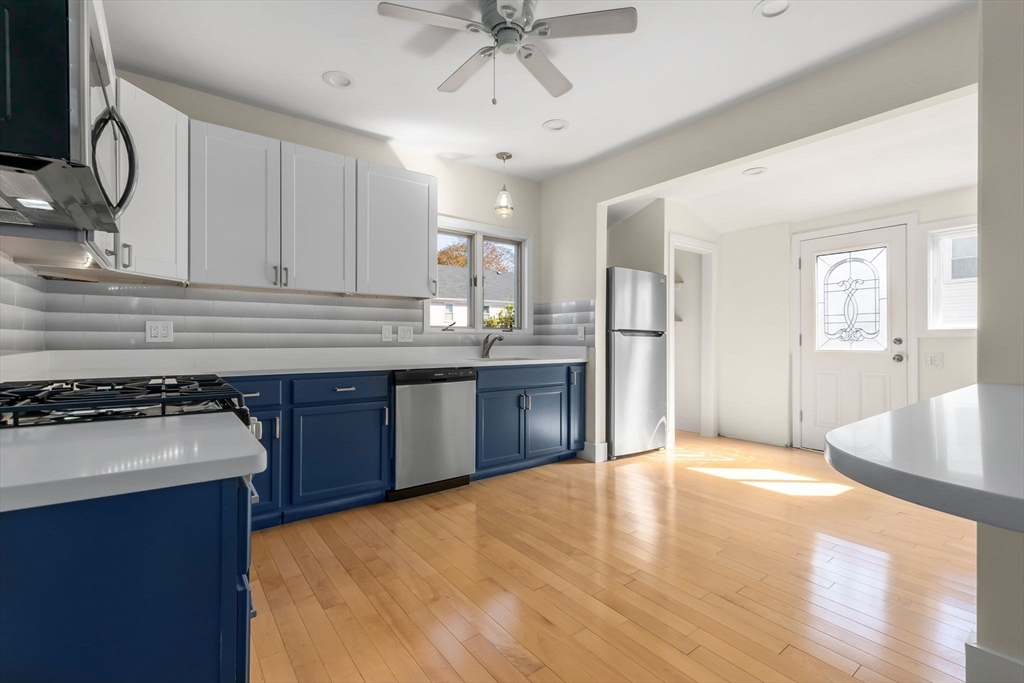 14 1/2 Hampshire Street Danvers, MA 01923 - Photo 8 of 37 a kitchen with stainless steel appliances granite countertop a sink stove and refrigerator
