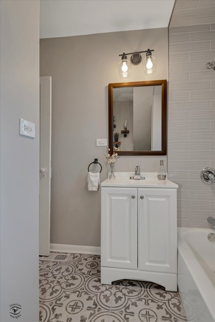 714 Gould Street Beecher, IL 60401 - Photo 16 of 29 a bathroom with a sink a vanity and mirror