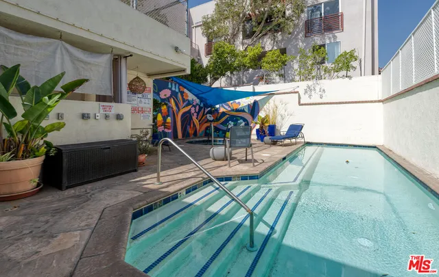 a view of a patio with a table and chairs
