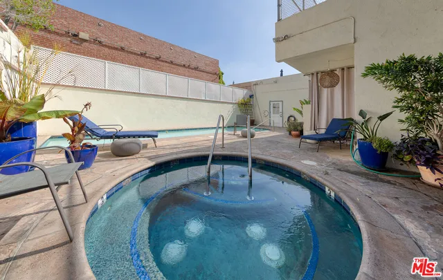 a view of a patio with table and chairs potted plants
