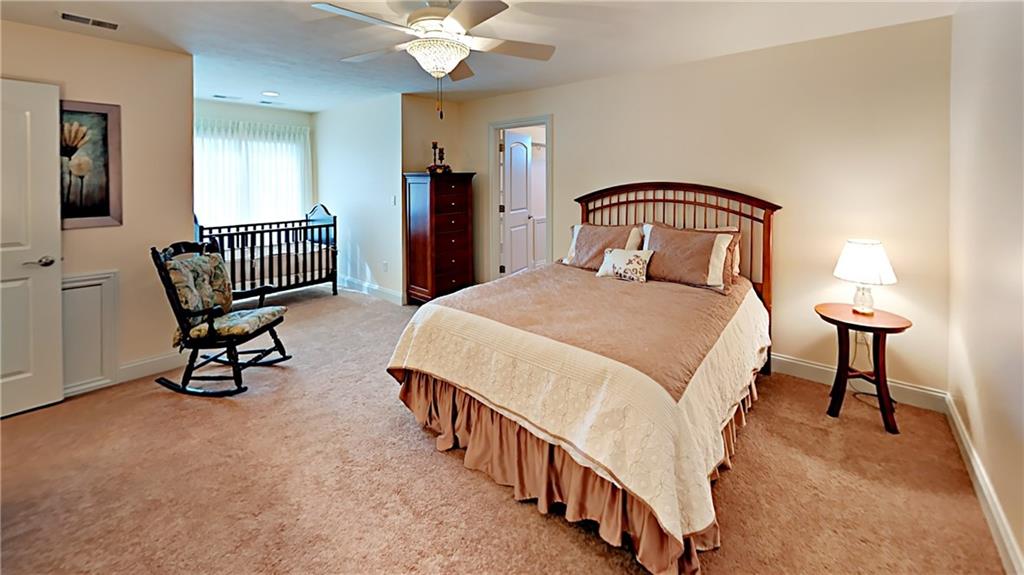 811 Mt Pleasant Road Mars, PA 16046 - Photo 16 of 25 a bedroom with a bed chair and a chandelier