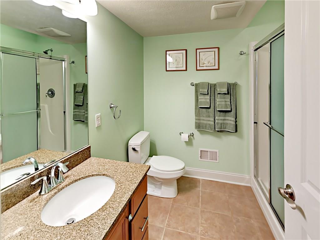 811 Mt Pleasant Road Mars, PA 16046 - Photo 22 of 25 a bathroom with a granite countertop toilet sink and mirror