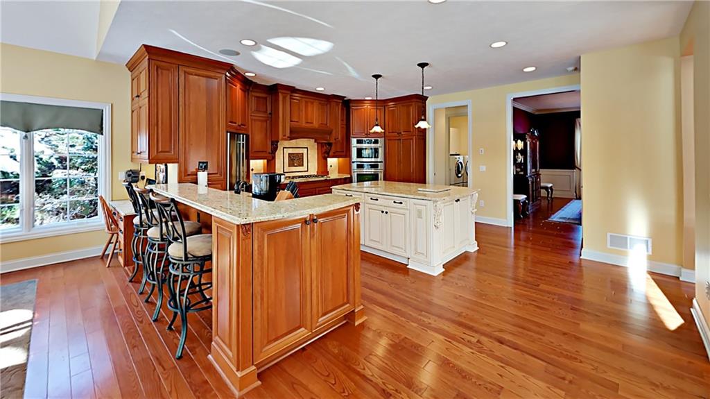 811 Mt Pleasant Road Mars, PA 16046 - Photo 7 of 25 a kitchen with stainless steel appliances kitchen island granite countertop a table chairs and a refrigerator