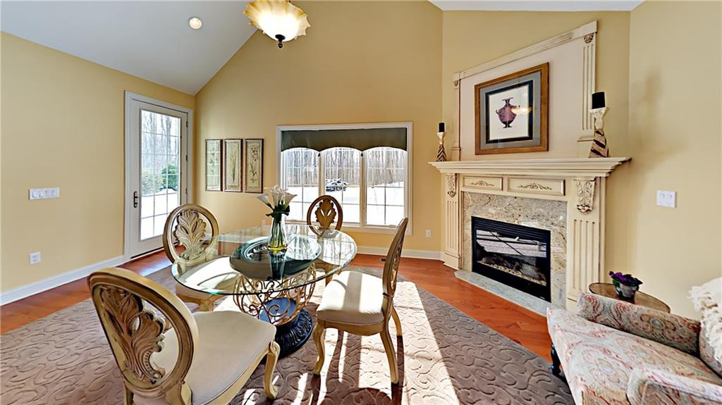 811 Mt Pleasant Road Mars, PA 16046 - Photo 9 of 25 a dining room with furniture a fireplace and wooden floor