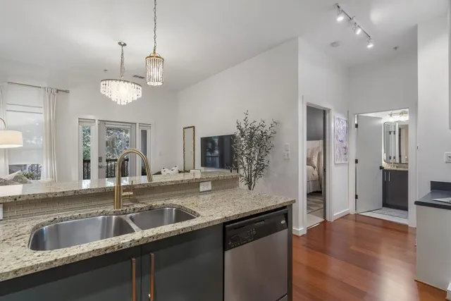 a view of a kitchen island a sink and refrigerator