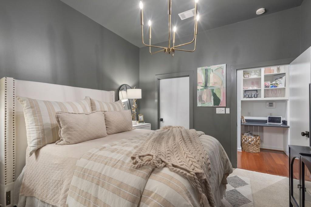 870 Inman Vlg Parkway Northeast, Unit 212 Atlanta, GA 30307 - Photo 15 of 23 a bedroom with a bed and a chair