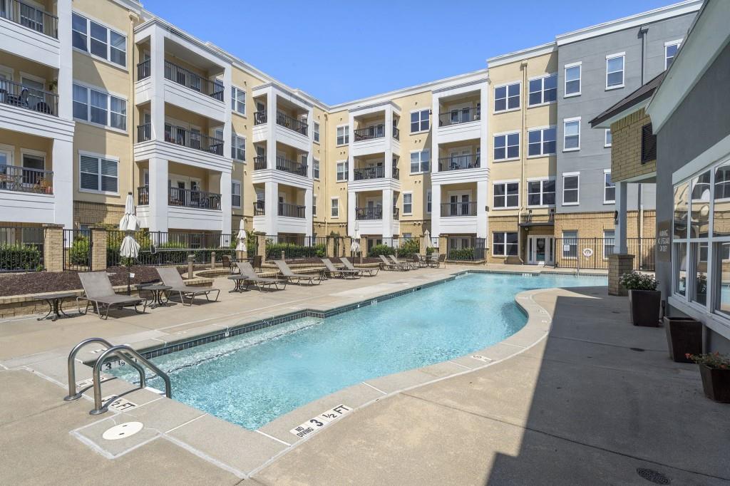 870 Inman Vlg Parkway Northeast, Unit 212 Atlanta, GA 30307 - Photo 17 of 23 a view of a swimming pool with outdoor seating