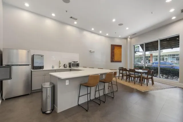 a kitchen with a table chairs and a refrigerator