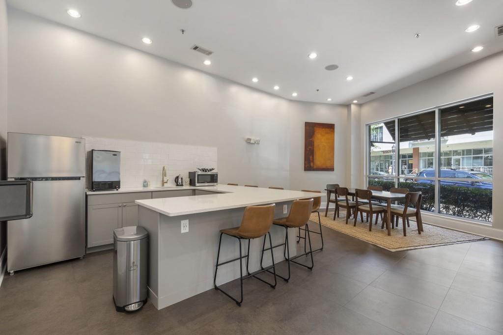 870 Inman Vlg Parkway Northeast, Unit 212 Atlanta, GA 30307 - Photo 20 of 23 a kitchen with a table chairs and a refrigerator