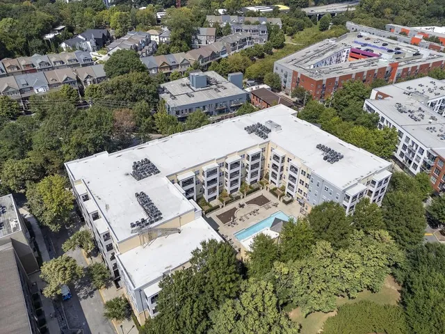 an aerial view of a house with garden space and street view