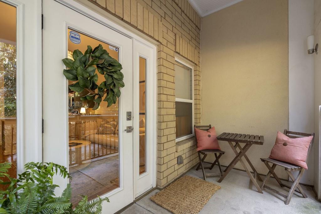 870 Inman Vlg Parkway Northeast, Unit 212 Atlanta, GA 30307 - Photo 5 of 23 a balcony with table and chairs and potted plants