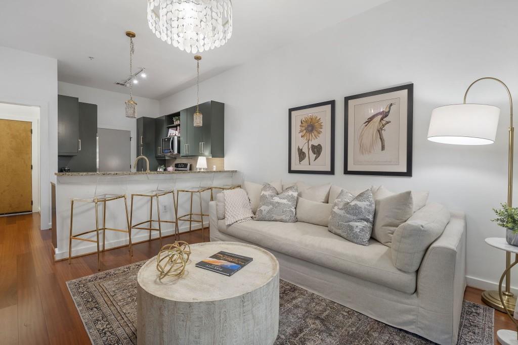870 Inman Vlg Parkway Northeast, Unit 212 Atlanta, GA 30307 - Photo 8 of 23 a living room with furniture and a chandelier