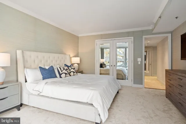 a large bedroom with a bed and a flat screen tv