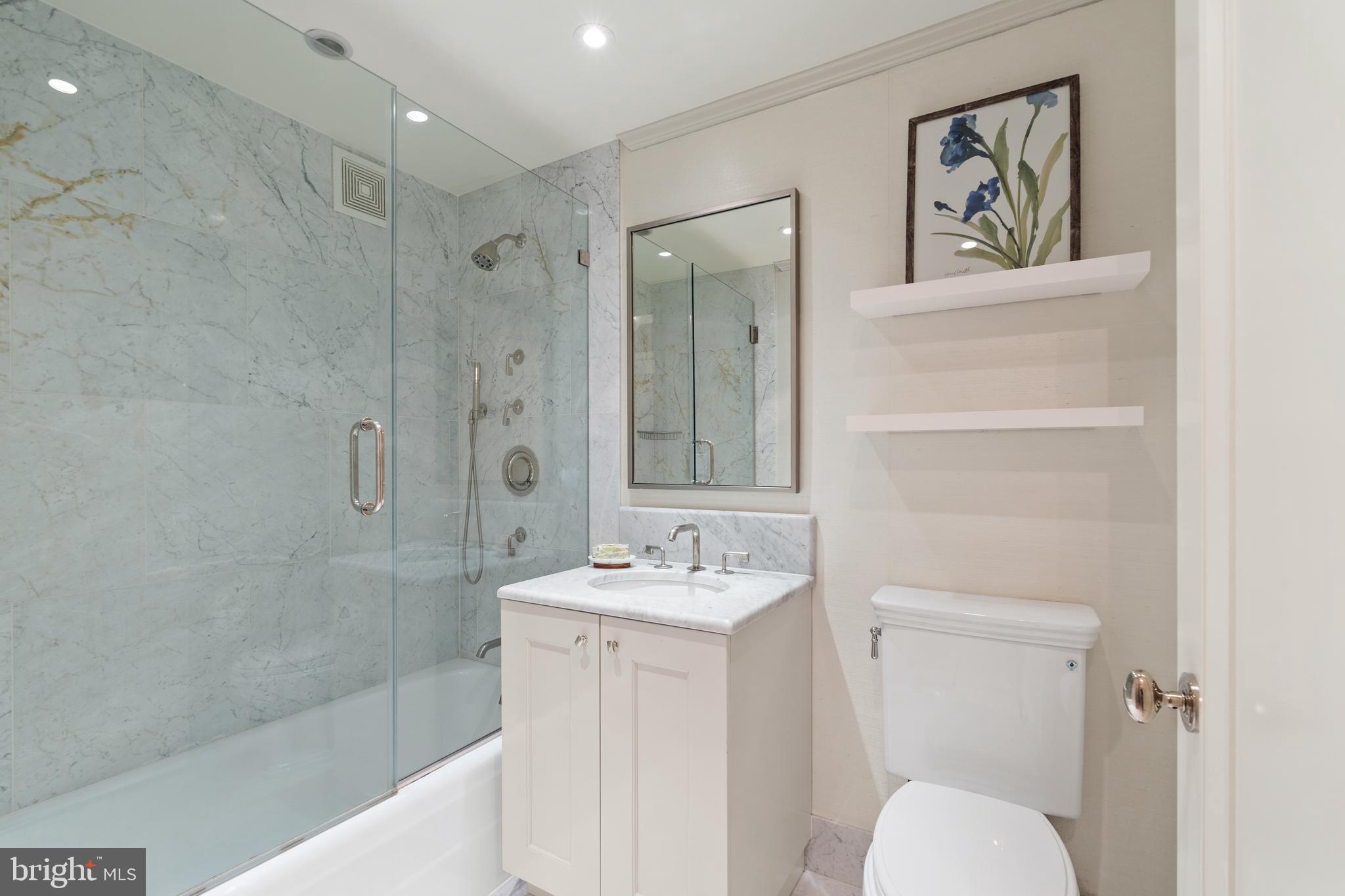 1111 23rd Street Northwest, Unit 4C Washington, DC 20037 - Photo 33 of 39 a bathroom with a granite countertop sink a toilet a shower and a mirror