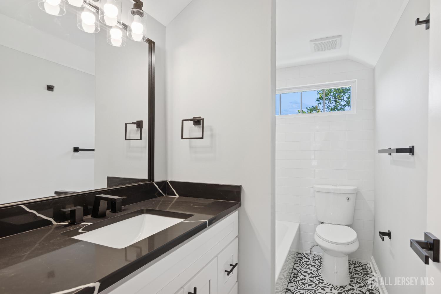 831 West Inman Avenue Rahway, NJ 07065 - Photo 15 of 35 a bathroom with a granite countertop sink and a mirror