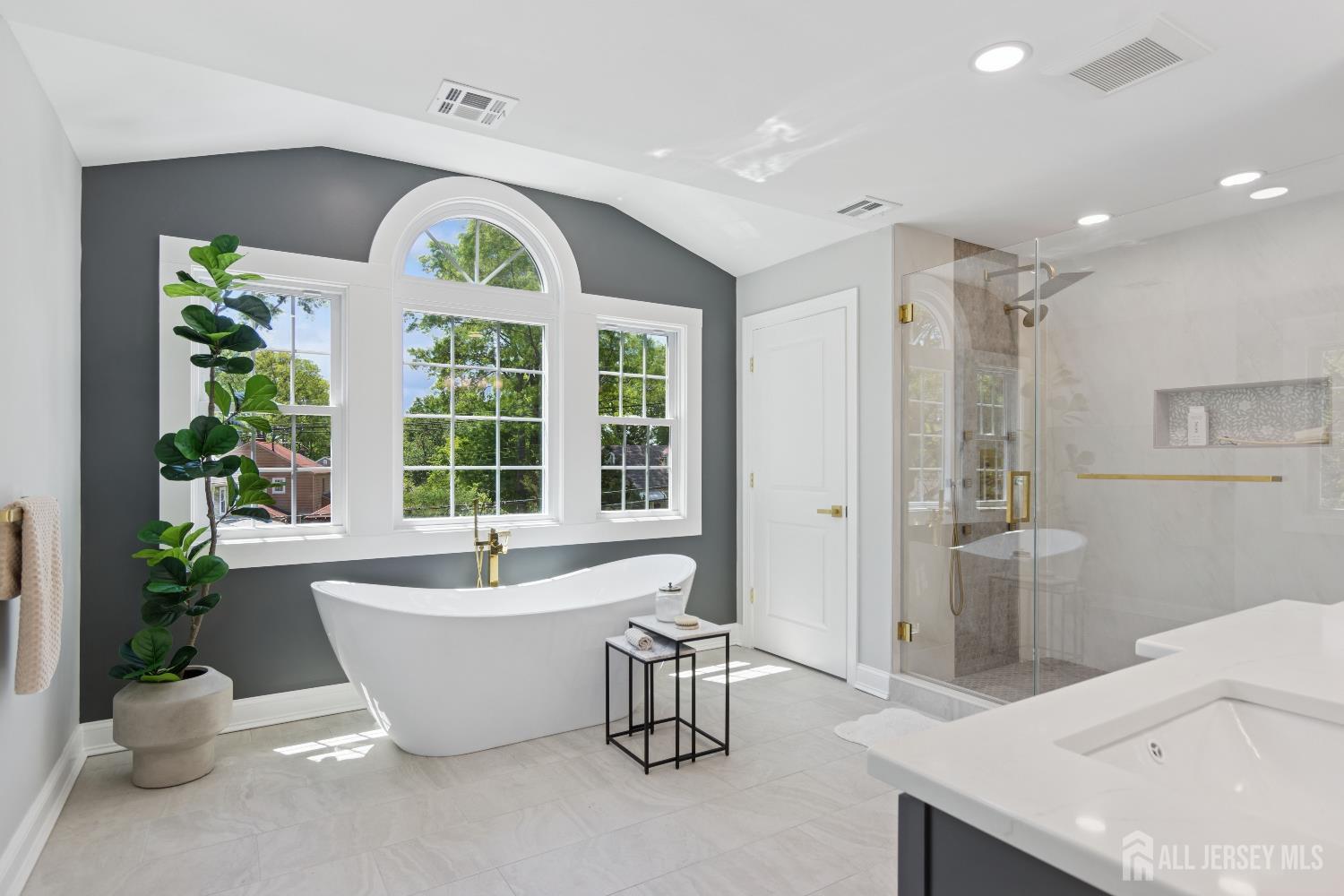 831 West Inman Avenue Rahway, NJ 07065 - Photo 22 of 35 a white bath tub sitting in a bathroom next to a window