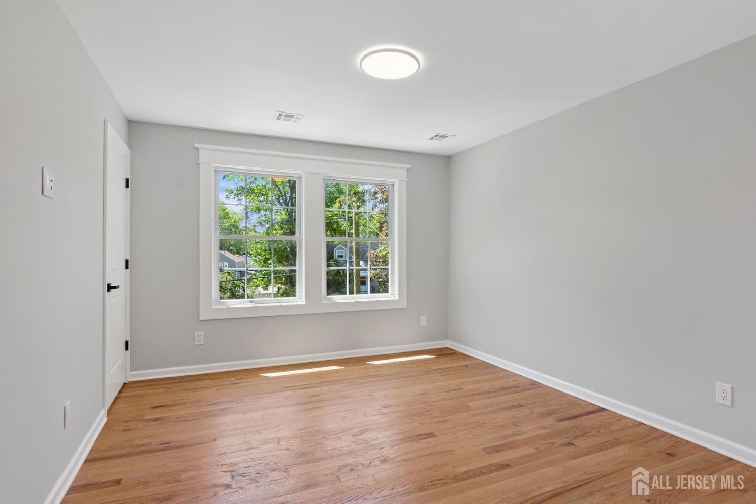 831 West Inman Avenue Rahway, NJ 07065 - Photo 25 of 35 wooden floor in an empty room with a window