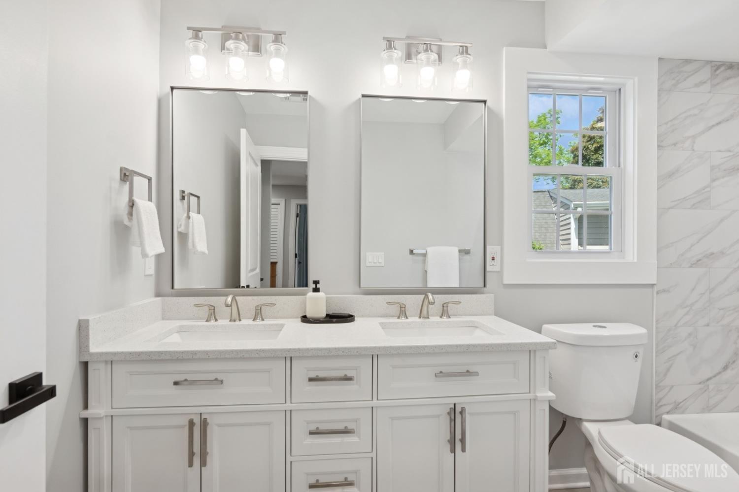 831 West Inman Avenue Rahway, NJ 07065 - Photo 26 of 35 a bathroom with a toilet sink and mirror