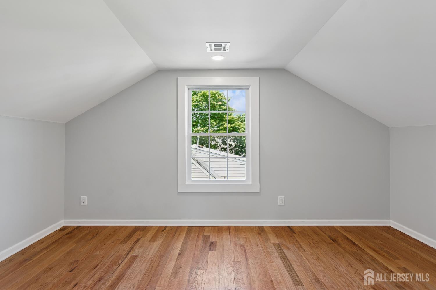831 West Inman Avenue Rahway, NJ 07065 - Photo 28 of 35 an empty room with wooden floor and windows