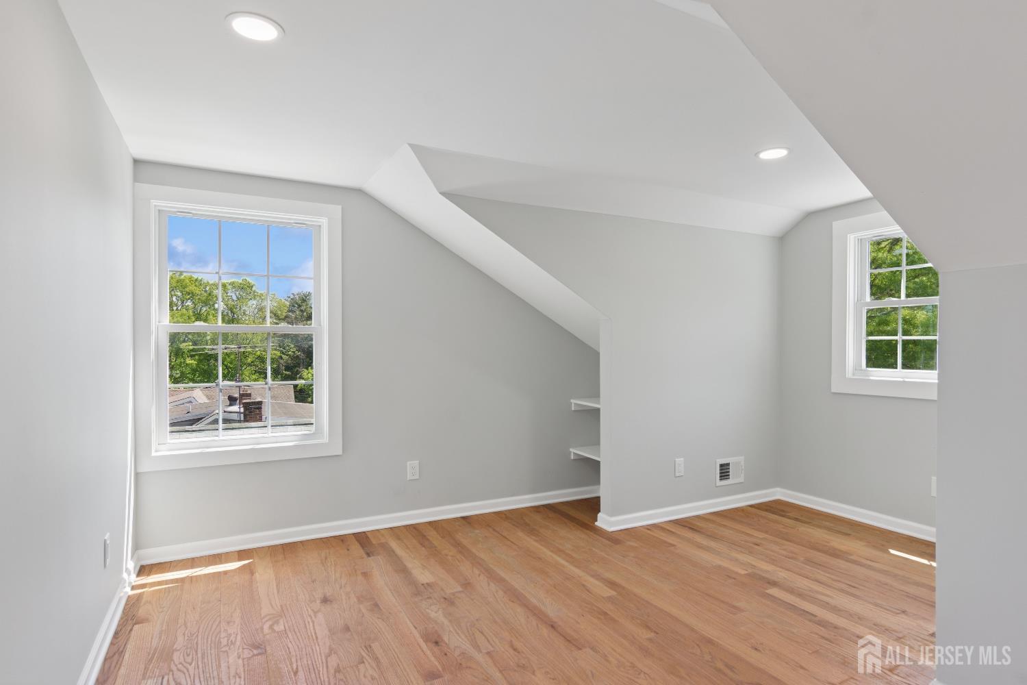 831 West Inman Avenue Rahway, NJ 07065 - Photo 29 of 35 a view of an empty room with wooden floor and a window