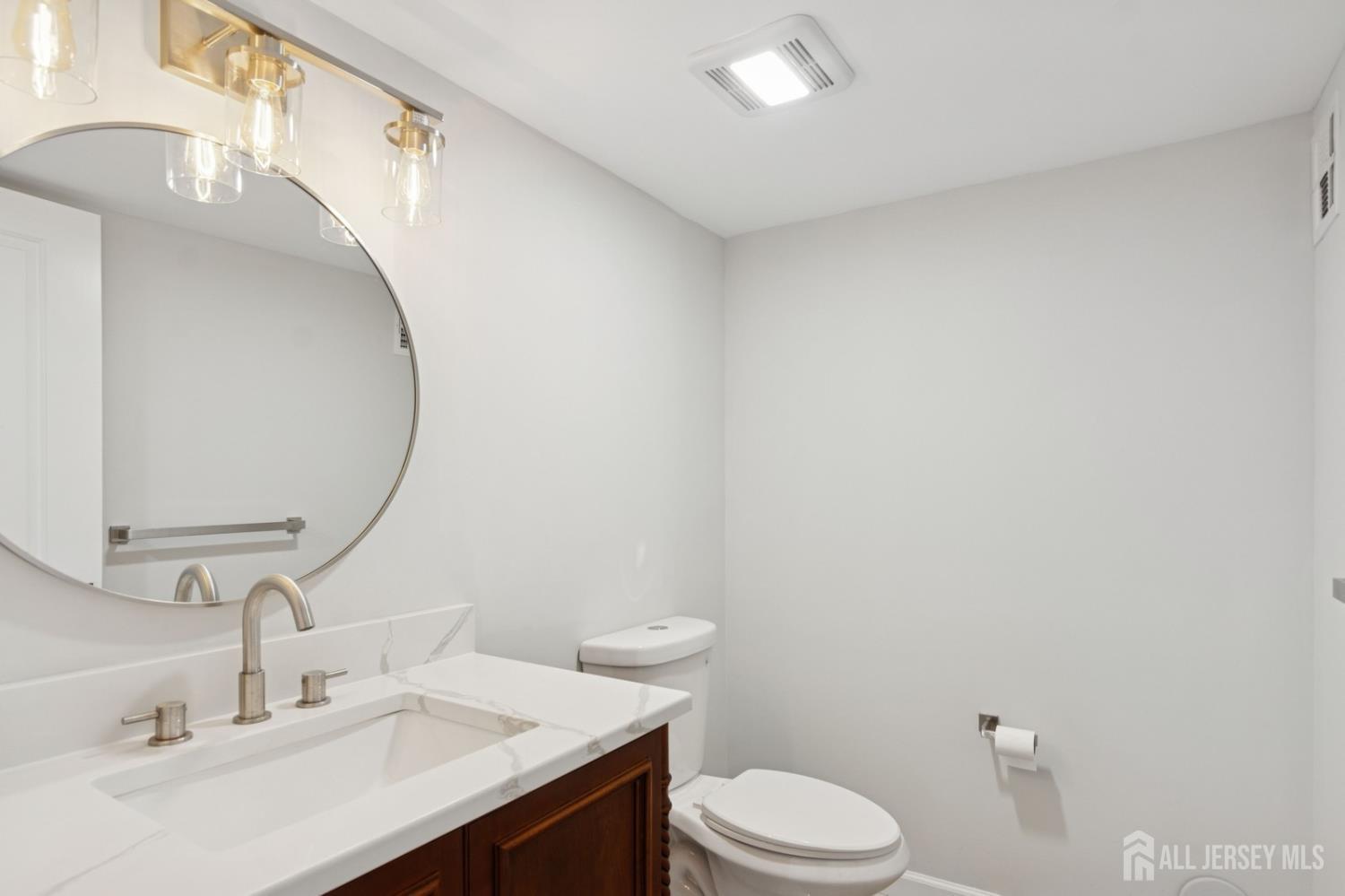 831 West Inman Avenue Rahway, NJ 07065 - Photo 35 of 35 a bathroom with a sink a toilet and mirror
