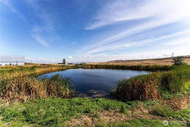 a view of a lake and green valley