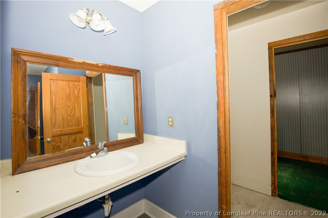 453 Heritage Farm Road Carthage, NC 28327 - Photo 17 of 50 a bathroom with a sink a vanity and a mirror