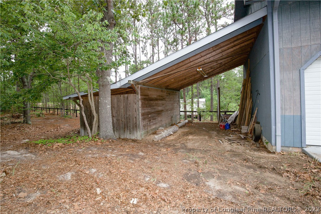 453 Heritage Farm Road Carthage, NC 28327 - Photo 29 of 50 a view of backyard with wooden fence and large trees