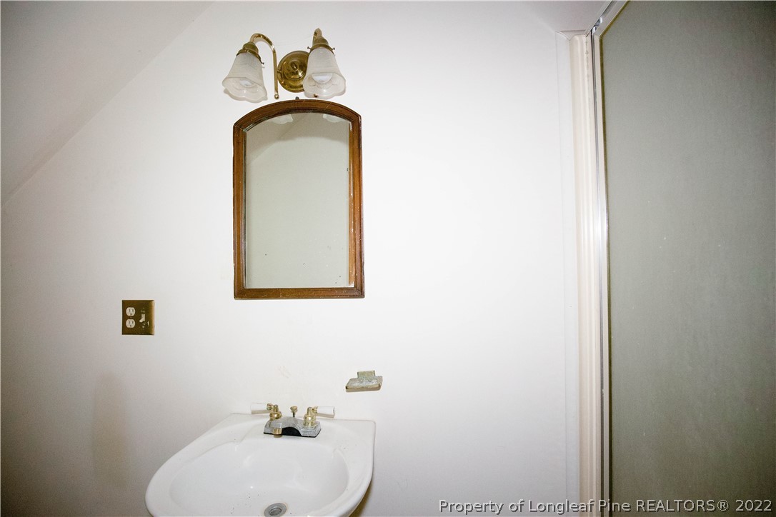 453 Heritage Farm Road Carthage, NC 28327 - Photo 34 of 50 a bathroom with a sink and mirror with toilet