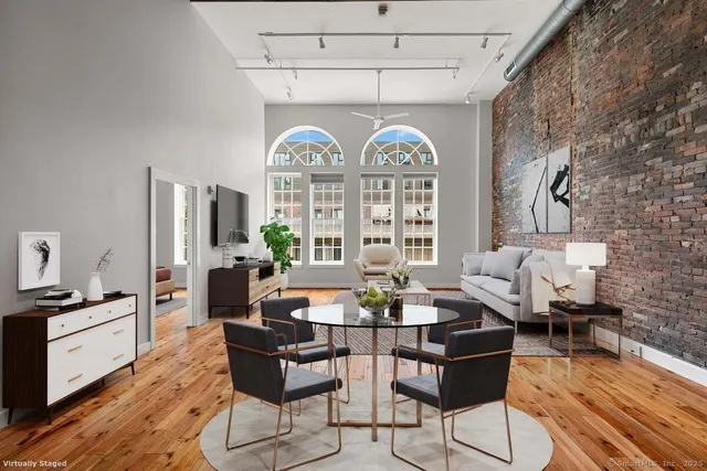 a view of a livingroom with furniture window and wooden floor