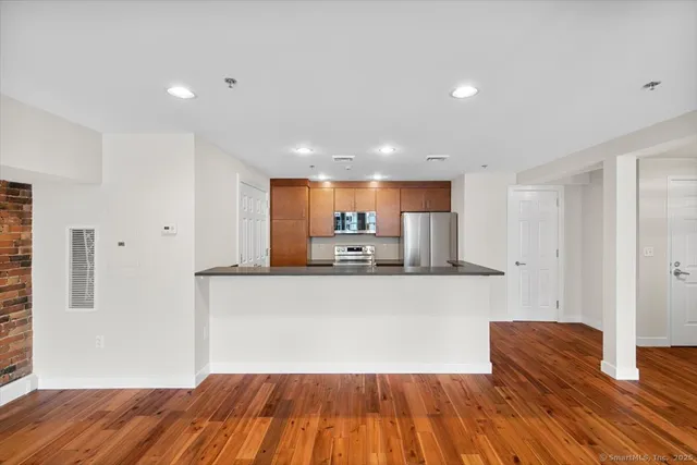 a room with wooden floors and natural light