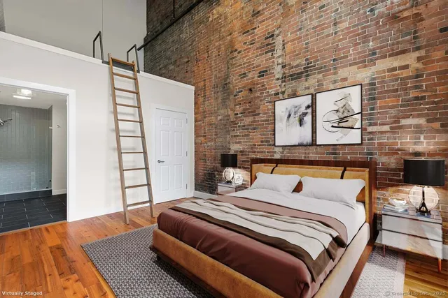 a bedroom with a bed and a night stand