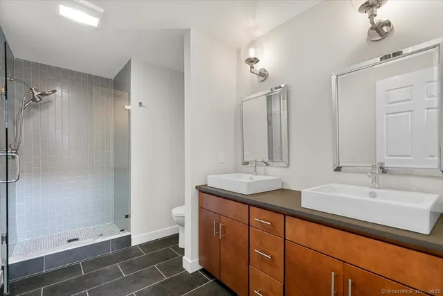 a bathroom with double sink and a mirror