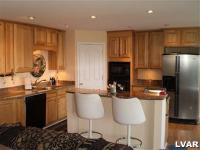 5219 Springmill Road Whitehall, PA 18052 - Photo 11 of 40 a kitchen with granite countertop a sink stainless steel appliances and cabinets