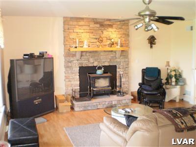 5219 Springmill Road Whitehall, PA 18052 - Photo 14 of 40 a living room with furniture and a fireplace