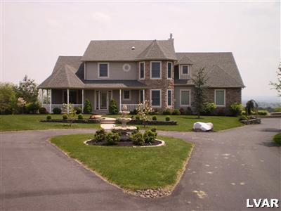 5219 Springmill Road Whitehall, PA 18052 - Photo 2 of 40 a front view of a house with swimming pool garden and outdoor seating