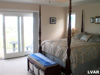 5219 Springmill Road Whitehall, PA 18052 - Photo 24 of 40 a bedroom with a bed and wooden floor