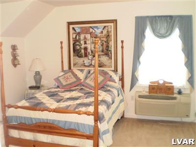 5219 Springmill Road Whitehall, PA 18052 - Photo 30 of 40 a view of a bedroom with a bed and glass door