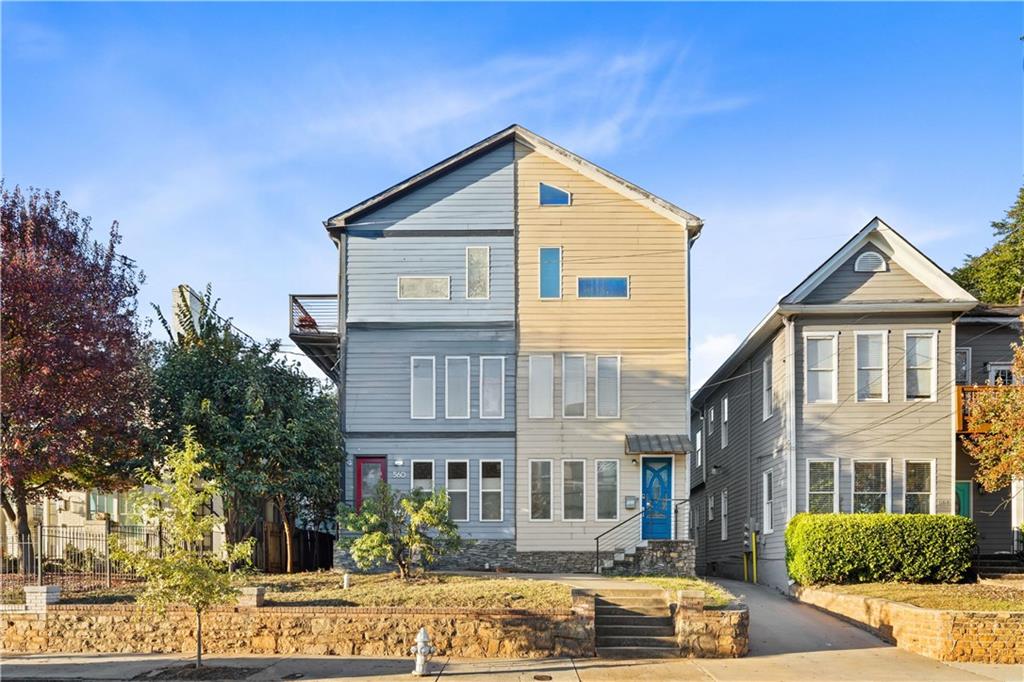 a view of a house with street next to a road