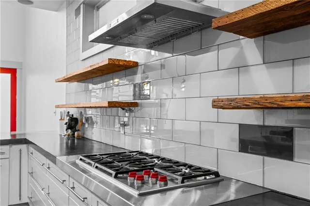 a stove top oven sitting inside of a kitchen