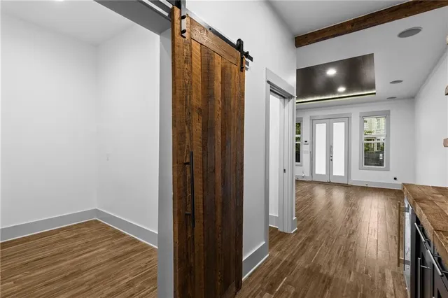 a view of a livingroom with wooden floor and staircase