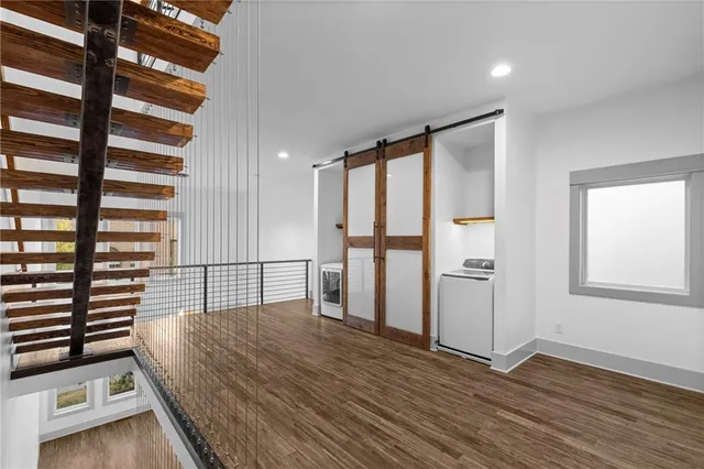 a view of bedroom with furniture and wooden floor