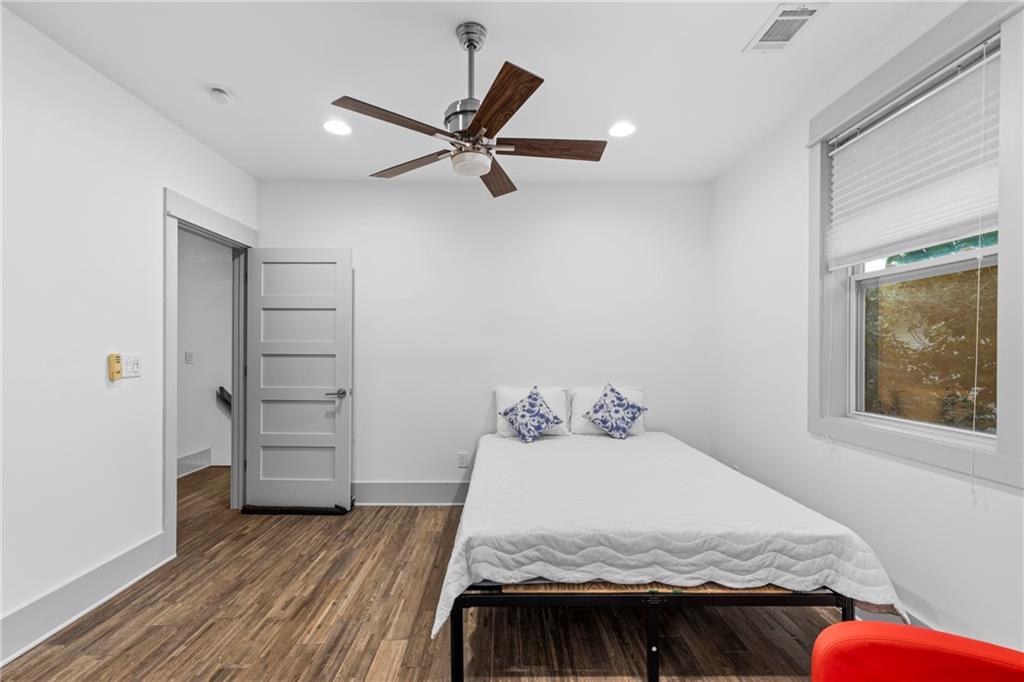 560 John Wesley Dobbs Avenue Northeast, Unit A Atlanta, GA 30312 - Photo 21 of 44 a bedroom with a bed and wooden floor