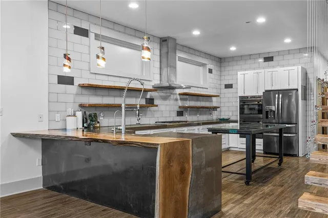 a kitchen with stainless steel appliances granite countertop a sink and cabinets